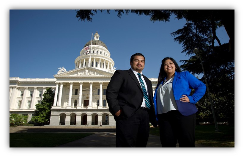 Two people standing in front of the California Capitol building in Sacramento, California